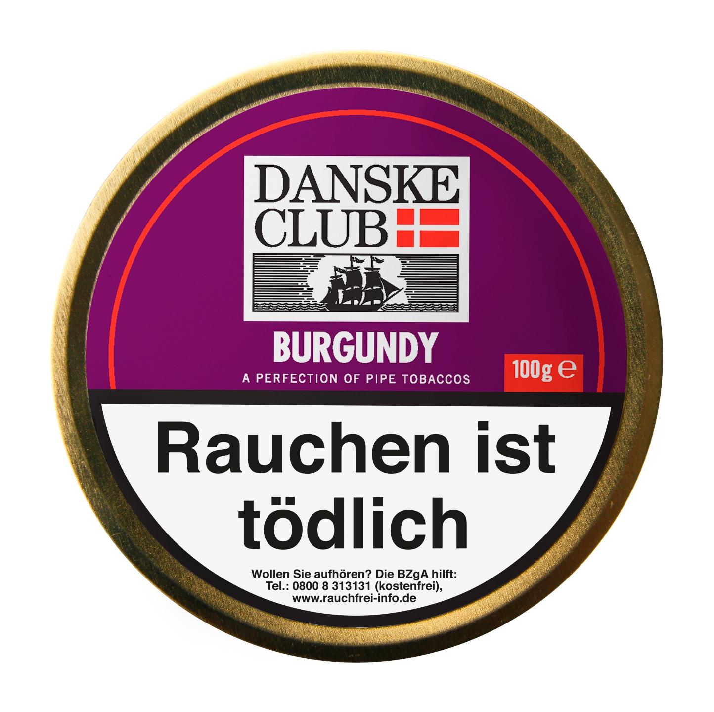 Danske Club Burgundy Pfeifentabak in der goldfarbenen 100-Gramm-Dose mit violetter Gestaltung, inklusive der gesetzlichen Warnhinweise auf der Vorderseite.