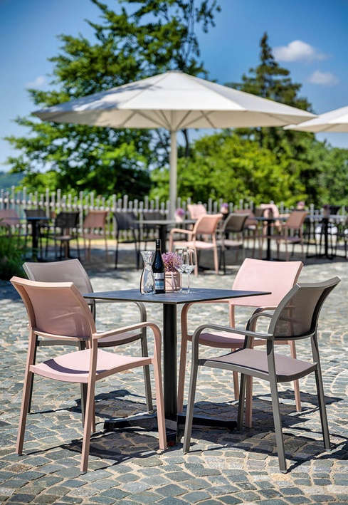 Colourful, stylish patio chairs on paving stone